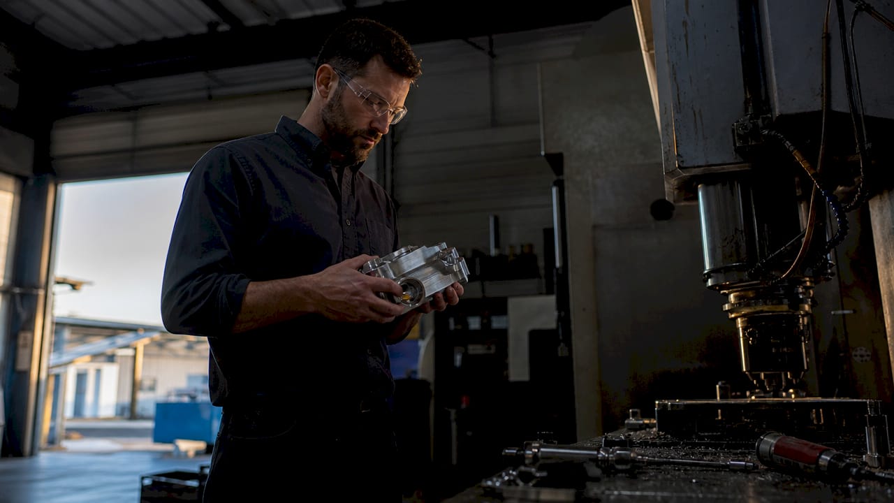 Engineer Inspecting Precision Machined Part In Shop Engineer inspecting precision machined part in shop