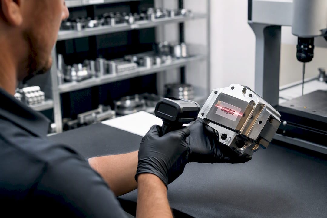 Hands scanning barcode on aerospace component